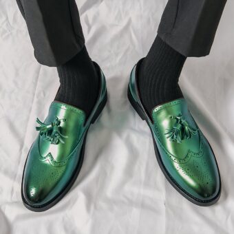 Men's metallic green tassel loafers with white background