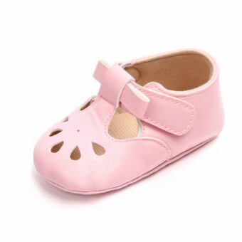 Pink moccasin with small buckle and toe holes on white background