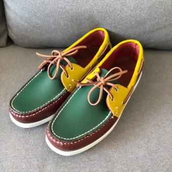 Yellow-green and brown loafers on a grey sofa