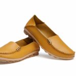 Flat leather moccasins in various colors for women with a white background