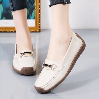 Leather loafers with gold detailing for women, featuring a grey background and a gold panel on the back