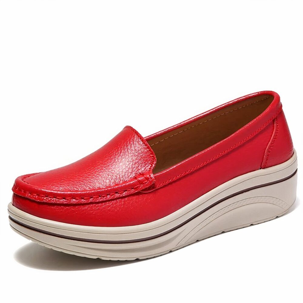 Moccasin in shiny synthetic leather, in red on a white background