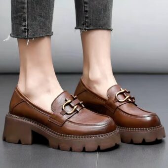 Women's retro-style leather loafers with grey background