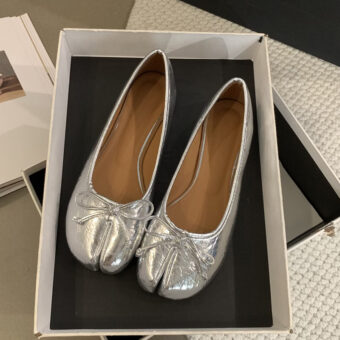 Silver Tabi ballerinas with decorative bow in an open box