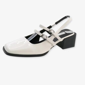 Single patent ballerina loafer with buckles and low heel on a white background