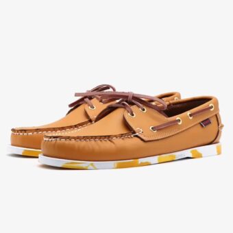 Brown leather boat loafers with colored sole for men on a white background