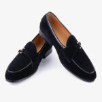 A pair of elegant suede loafers for men on a plain white background