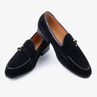 A pair of elegant suede loafers for men on a plain white background