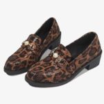 Snake-effect leopard loafers with pearl detail on a white background