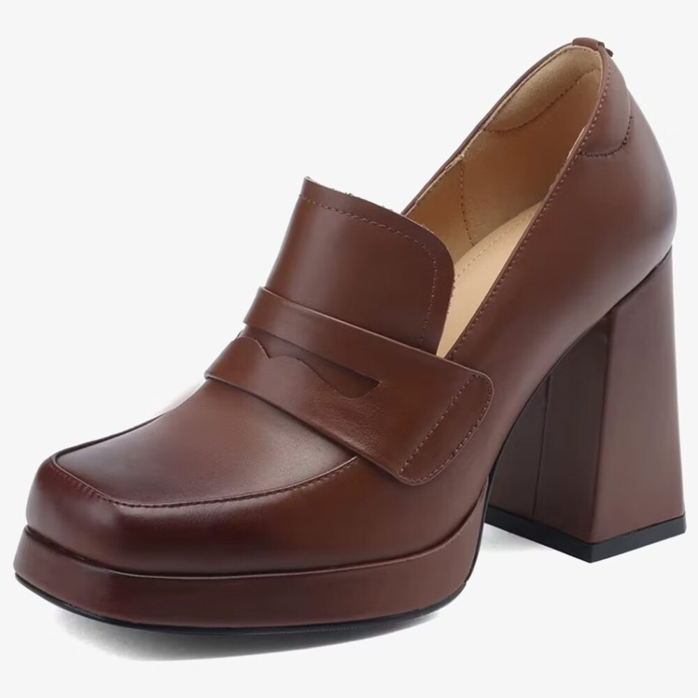 A brown heeled leather loafer for women on a white background