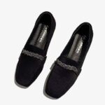 Elegant suede loafers with rhinestone chains on a white background