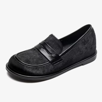 Single black leather and horsehair loafer on a white background