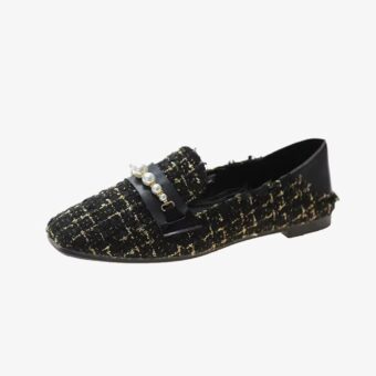 Single black elegant loafer in tweed and pearls on a white background