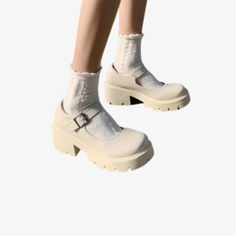 Woman with only her legs showing, wearing Chunky Mary Jane loafers with thick soles, with white socks.