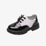 A patent leather lace-up loafer for boys in shiny black with white trim