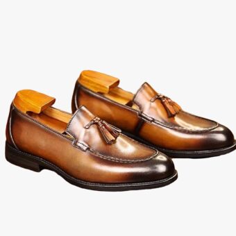 Genuine leather dress loafers with tassels for men on a white background