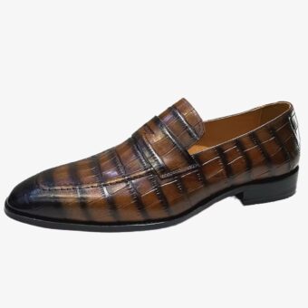 An Italian leather crocodile-effect loafer for men on a plain white background