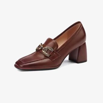 A brown vintage-style leather heeled loafer for women on a plain white background
